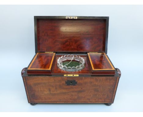 An early 19thC mahogany tea caddy of rectangular form with inlaid ebony detail, raised on bun feet, with fitted interior with