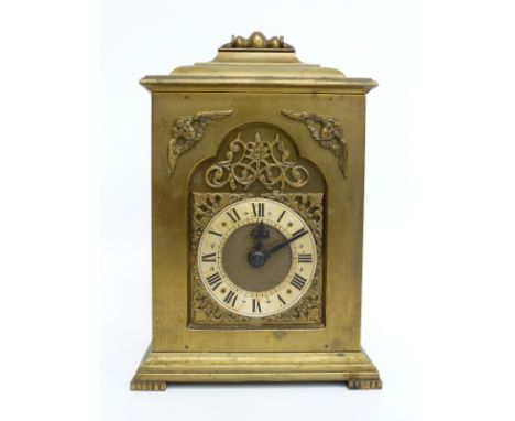 A brass carriage style / bracket clock, the keyless movement stamped Rotherham, England, the dial with Roman silvered chapter