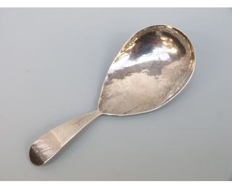 A George IV hallmarked silver tea caddy spoon with hammered decoration, London 1824, maker William Seaman