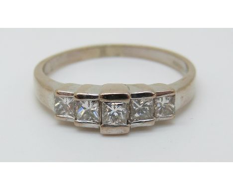 An 18ct white gold ring set with princess cut diamonds, the largest stone approximately 0.18ct, 4.18g (size R) 