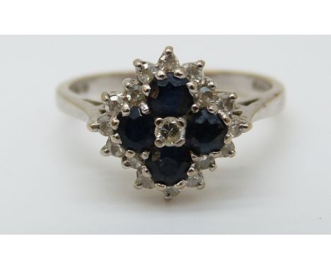 An 18ct white gold ring set with sapphires and diamonds in a cluster (size K) 