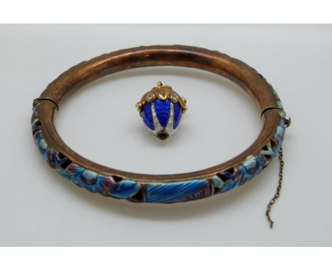 An egg pendant set with blue and white enamel together with a white metal pierced bangle set with purple and blue enamel