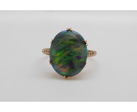 A Victorian 15ct gold ring set with a black opal cabochon, 1.5cm x 1.2cm (size N)