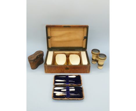 A cased gentleman's ivory brush set, together with two pairs of cased ivory opera glasses and a button hook set, with crest t