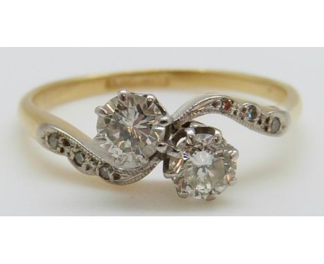 An 18ct gold ring set with two round cut diamonds each measuring approximately 0.35ct (size P)