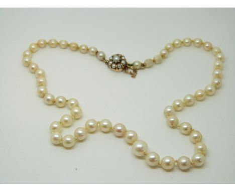 A pearl necklace with 14ct gold clasp set with pearls, and a pair of pearl earrings