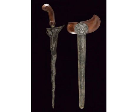 dating: 20th Century provenance: Giava, Undulated double-edged blade, in fine pamor, with chiselled and grooved base. Wooden 