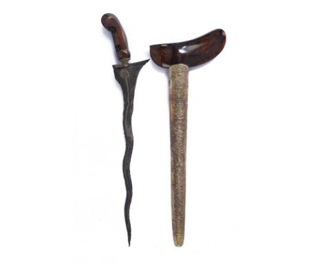 dating: 20th Century provenance: Giava, Undulated double-edged blade, in fine pamor, with grooved base. Wooden ukiran, slight