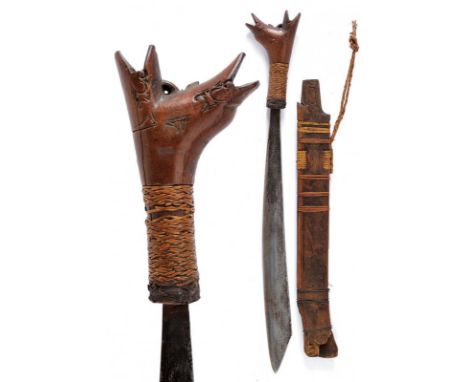 dating: circa 1900 provenance: Kalimantan, Single-edged blade, of typical shape. Wooden grip, embossed, base with vegetable w