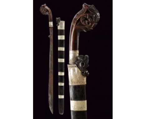 dating: circa 1900 provenance: Sumatra, Curved, single-edged blade with dent at the base. Horn grip, embossed with floral mot