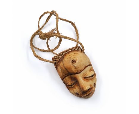 Face mask pendant (Gikhokho Mask) of the Pende people from Congo, made of carved material, late 19th or early 20th century. P