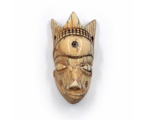 Face mask pendant (Gikhokho maskette) of the Pende people from Congo, made of carved material, late 19th or early 20th centur