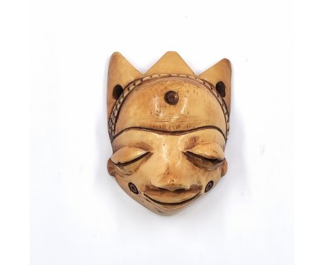 Face mask pendant (Gikhokho maskette) of the Pende people from Congo, made of carved material, late 19th or early 20th centur