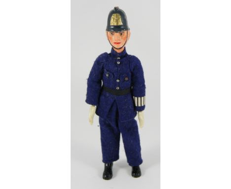 Bucherer Policeman metal jointed figure, Swiss 1920s, with moulded and painted head and helmet, white gloved hands and boots,