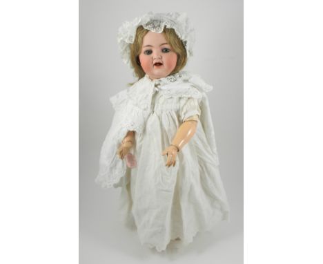 K&R 126 toddler bisque head doll, German circa 1910, with weighted blue glass eyes, lashes, open mouth with tongue, brown wig