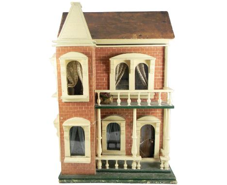 A painted wooden dolls house, English circa 1910, the façade with red painted brick effect, cream painted widow and door surr