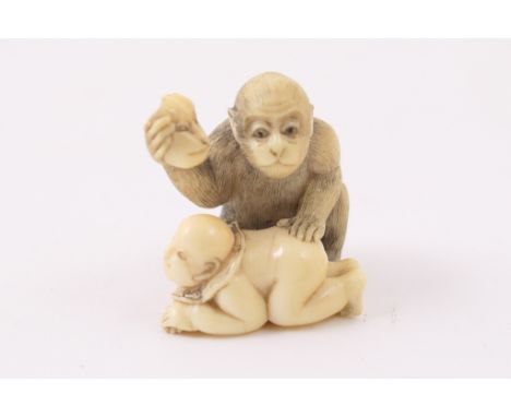 Japanese carved ivory netsuke, Meiji (1868-1912), carved as an ape holding a mask to a boy, signed, 4cm