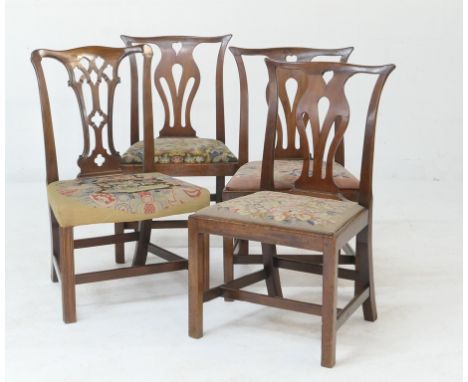 Three Georgian mahogany side chairs in the Chippendale style, each with a needlework upholstered drop in seat, and a further 