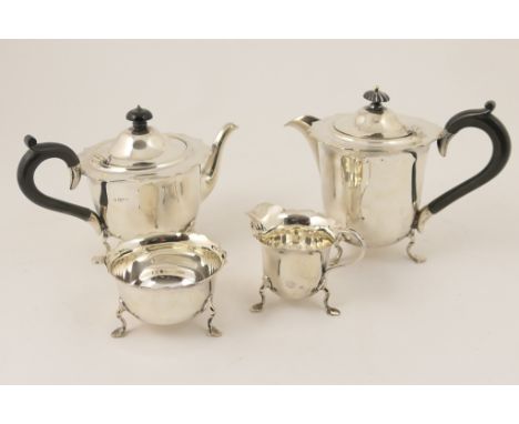 Matched silver four piece tea service, comprising teapot and matching hot water jug, Sheffield 1951, plain circular form with