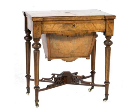 Victorian burr walnut games/work table, circa 1845, the rectangular top with quartered veneers swivelling open to reveal inla