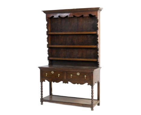 Reproduction oak cottage dresser, having a dentil cornice with shaped frieze over three plate shelves with boarded back, over