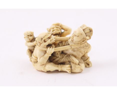 Japanese carved ivory netsuke, Meiji (1868-1912), carved as a figure with three oni, signed, 5cm