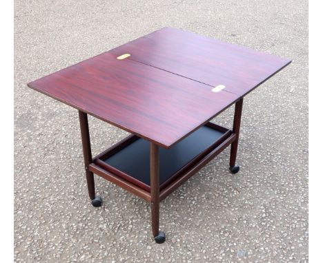1980's Teak metamorphic coffee table/entertainment trolley with a removable tray undertier, H. 63.5cm, L. 70cm, W. 44cm (fold