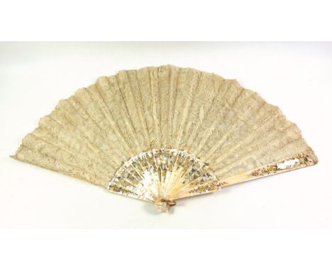 Late 19th Century French floral lace and mother-of-pearl fan, the end staves carved with a figure with a musical instrument b