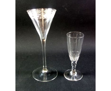 A plain stemmed toasting glass, circa 1750, the drawn trumpet bowl with engraved floral rim, on a long stem, over a conical f