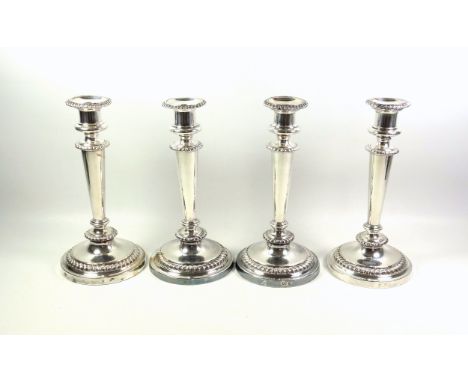 Set of 4 Regency Old Sheffield Plate candlesticks, each with a campana shaped capital, gadrooned decoration, and a tapering c