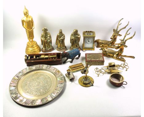 A brass carriage clock and various other brass items to include weighing scales, candle snuffers, a wall hanging Aztec or May