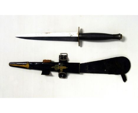 Fairbairn Sykes 3rd pattern Commando knife, black ribbed handle and scabbard with later decoration and buckle, 7 inch blade.