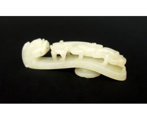 Chinese pale celadon jade belt hook, carved and pierced with a chilong confronting the dragon head terminal, 10cm.Condition: 