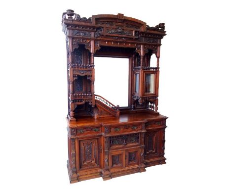Impressive Late 19th Century North American carved walnut side cabinet of monumental proportions, with a shallow arched pedim