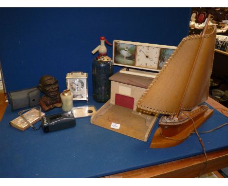 A small quantity of miscellanea including a vintage Soda Syphon, onyx lighter, table lamp in form of yacht, black cast money 