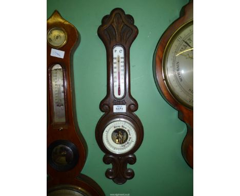 A J.G. Banjo barometer in carved surround.