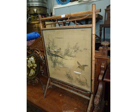 A Chinoiserie Bamboo framed firescreen, the silken panel with depictions of water-fowl to one side and eastern pots to the ot