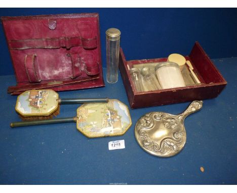 A burgundy leather vanity case with contents a/f., plus embroidered comb and brush set.