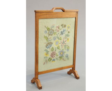 ROBERT INGHAM&nbsp;
A KINGPOST OAK FIRESCREEN, with carrying handle and glazed needlework panel, signed. 81cm high by 53cm wi