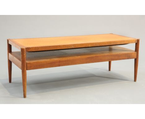 A DANISH TEAK COFFEE TABLE WITH REVERSIBLE TOP, the rectangular top with upholstered seat to the underside, raised on four ta