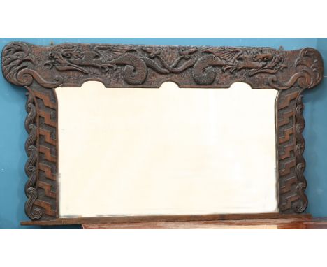 A LARGE ARTS AND CRAFTS CELTIC REVIVAL OAK OVERMANTEL MIRROR, CIRCA 1900, signed FW and dated 1900, carved with dragons and A