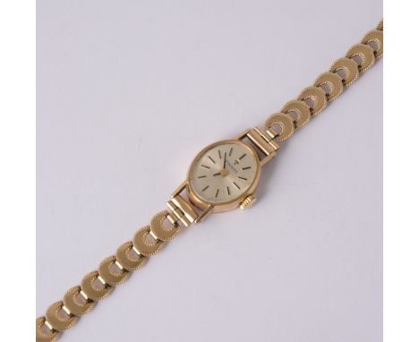 Tissot - A lady's 9 carat yellow gold bracelet watch, oval silvered baton dial in a 9 carat yellow gold case fitted with a ha