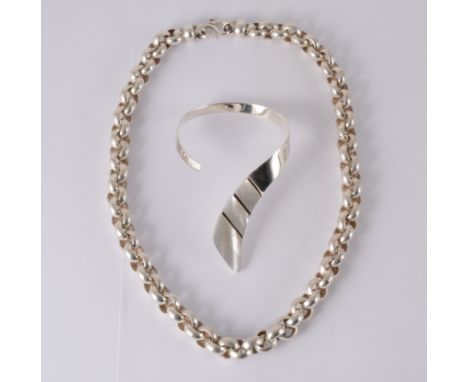 A contemporary white metal bangle marked 925 inset with three slices of mother-of-pearl to front, a heavy circular belcher li