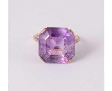 An amethyst dress ring, the 15.5mm square step cut stone with canted corners, showing colour banding, four claw set in a rose