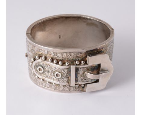 A Victorian silver half hinged bangle, raised detail to front in the form of a buckle with ivy leaf engraving, width 36mm, in