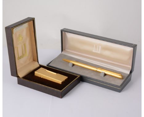 A Dunhill gold-plated cigarette lighter in a fine bark textured design - cased, a Dunhill gold-plated ball point pen with ver