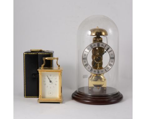 Reproduction skeleton clock, by Hermle, striking on a bell, under a glass dome, 30cms and a modern quartz carriage clock, cas
