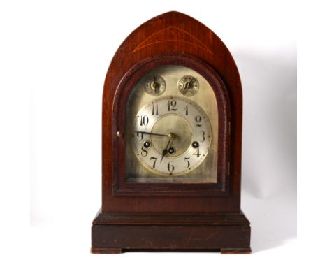 Edwardian stained wood mantel clock, lancet case, arched silvered dial, the movement striking on five gongs, 40cms.