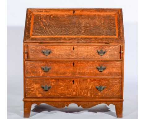 George III Country Made oak bureau, fall front enclosing interior with shelves and drawers, three long drawers below on brack