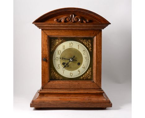 An oak cased shelf clock,  brass dial with corner spandrels and cream painted arabic numeral chapter ring, plain domed top ca